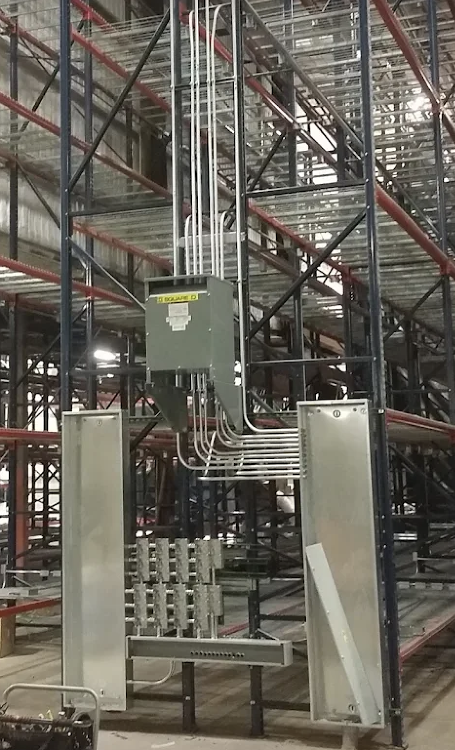 Suspended transformer and switchgear inside a warehouse rack system