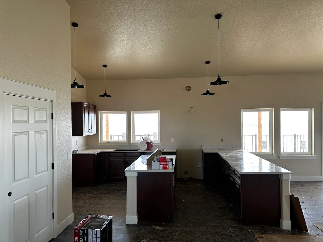 New construction kitchen with pendant lighting over island and bar