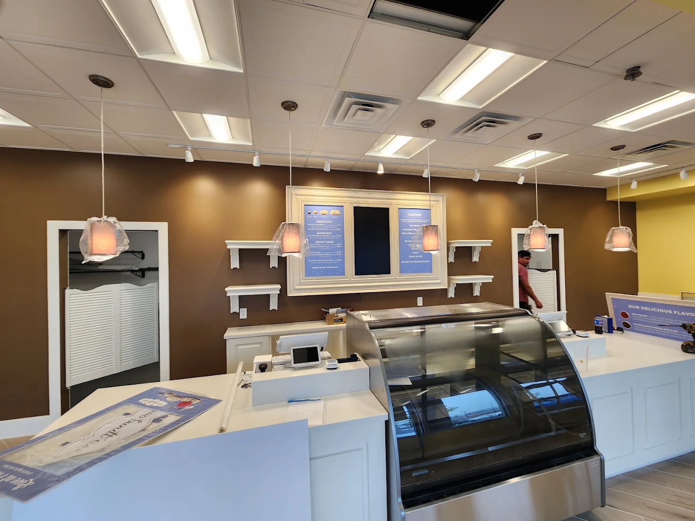 Finished bakery retail space with pendant and track lighting installed